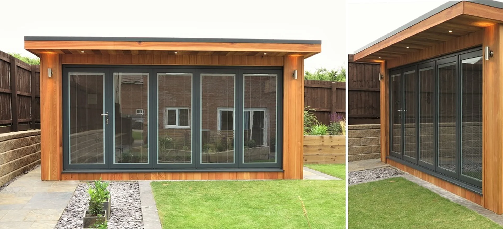 Cedar-clad garden room with anthracite bi-fold doors and flat overhanging roof, set in a landscaped garden