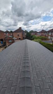 Tapco slate-effect roof tiles on a garden annexe, residential backdrop