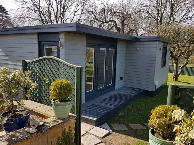 Grey weatherboard granny annexe with ramped decked entrance