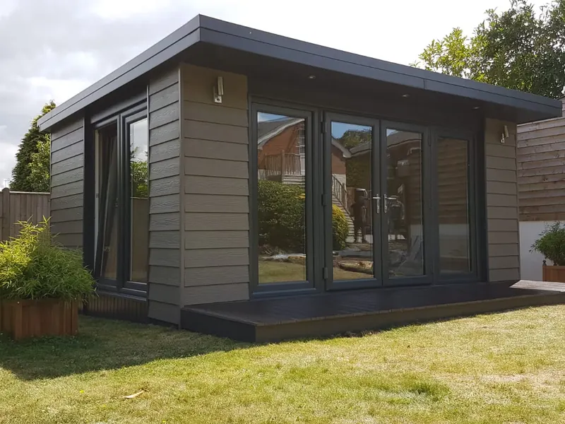 Bespoke insulated garden office with grey cladding, French doors and decki