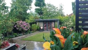 View of the garden in the Eltham project with the garden room in the background