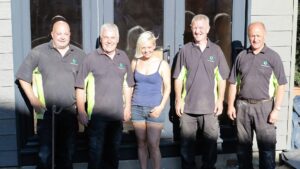 The Green Room Team that worked on the build standing in front of the garden room.