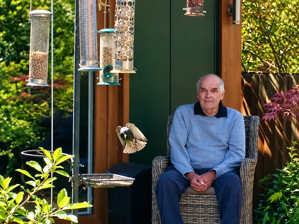 John watching the birds feed outside his garden annexe