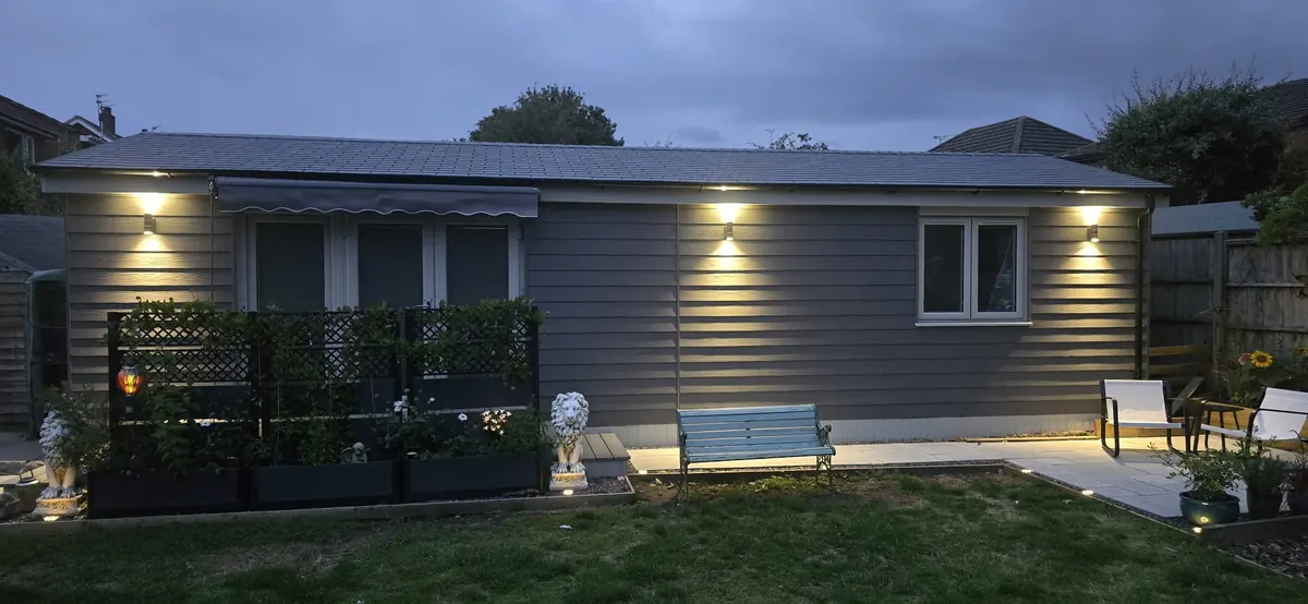 The Ridgemount Garden Annexe in the evening with exterior lighting.